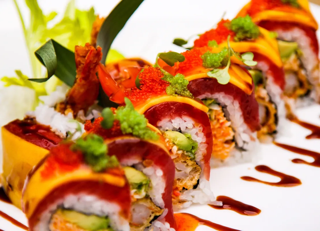 Sushi roll with sauce and herbs